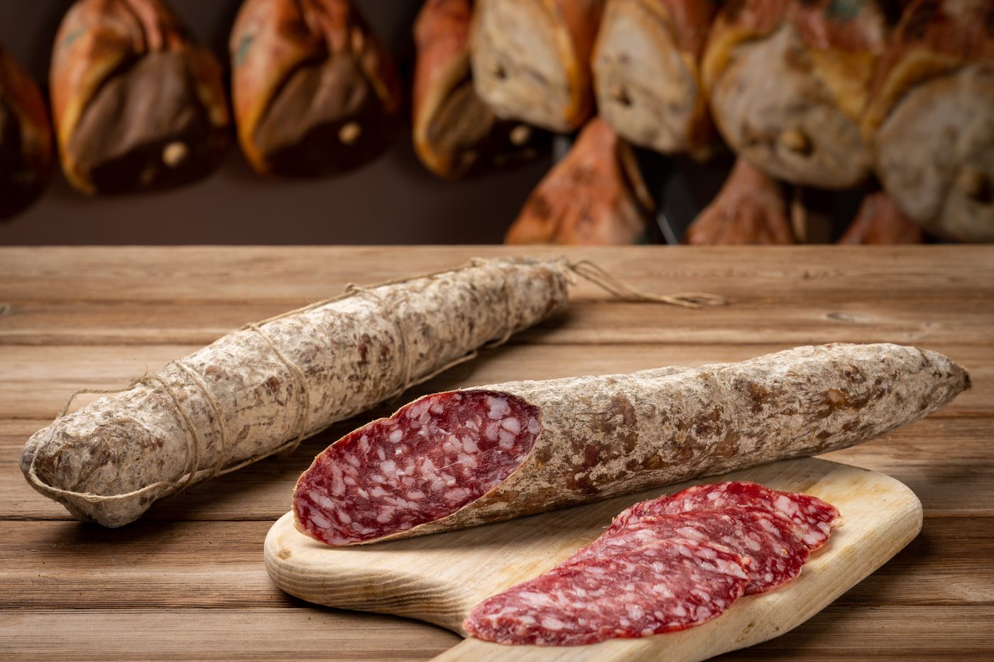 Salame Felino IGP e strolghino affettati su tagliere di legno